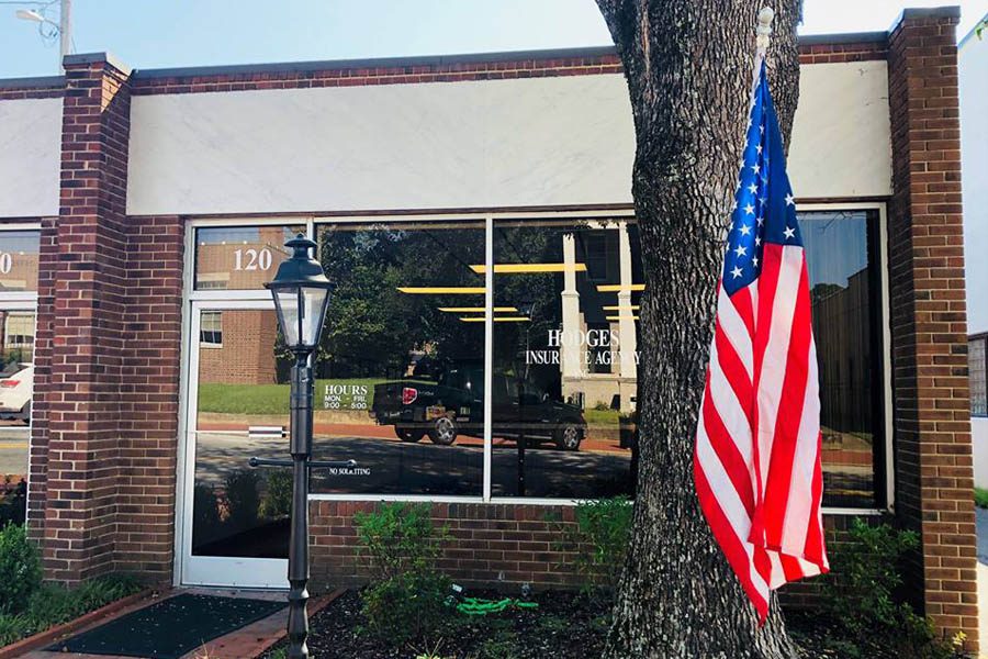 Contact Us - Louisburg, NC Insurance Building with an American Flag Out Front